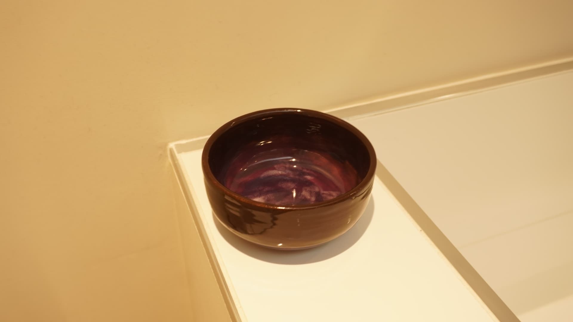 Plum & Petal Bowl · Wheel-thrown · Spectrum 1134 Chocolate + Mayco FN234 Royal Purple, PC602 White Cascade (petal detailing inside) — Ceramic work by RuiXuan Xu — Club