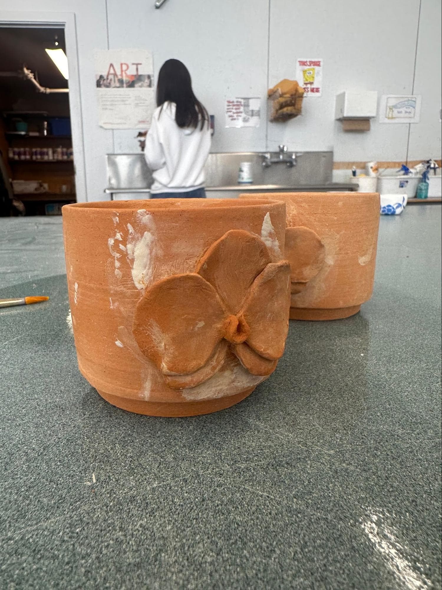 Doubled Orchid Cups · sketch → bisqueware → glazed → glazeware · trimmed to fit · Handbuilt floral and handle — Ceramic work by RuiXuan Xu — School