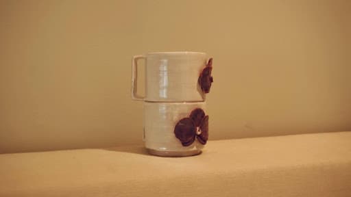 Doubled Orchid Cups · sketch → bisqueware → glazed → glazeware · trimmed to fit · Handbuilt floral and handle — Ceramic work by RuiXuan Xu — School