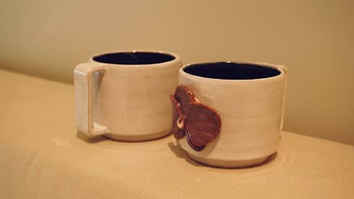 Doubled Orchid Cups · sketch → bisqueware → glazed → glazeware · trimmed to fit · Handbuilt floral and handle — Ceramic work by RuiXuan Xu — School