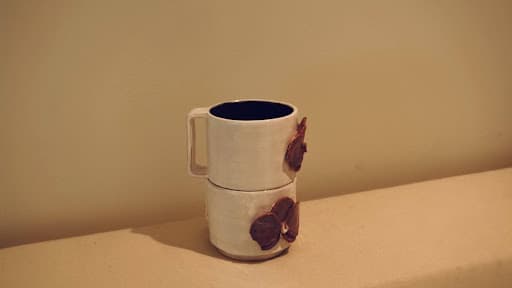 Doubled Orchid Cups · sketch → bisqueware → glazed → glazeware · trimmed to fit · Handbuilt floral and handle — Ceramic work by RuiXuan Xu — School